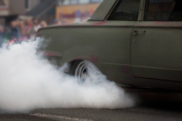 istock Car rear wheel burnout at street 946868294