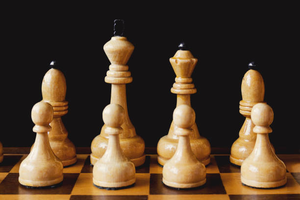 istock Wooden chess white pieces: king, queen. bishops and pawns 946872886