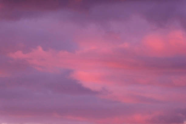 istock Close-up of purple coloured clouds during sunset. 946874598