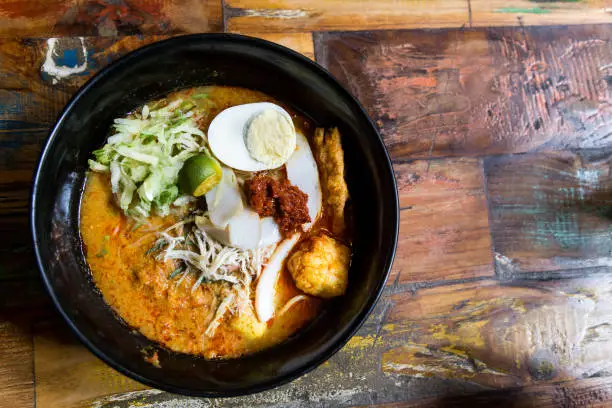 Serving of Nyonya Laksa, popular spicy noodle soup delicacy in Malaysia