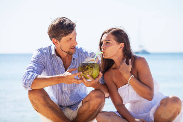istock Couple drinking coconut cocktail 946881086