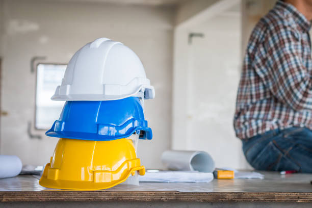 istock The safety helmet and the blueprint on table at construction site 946881550