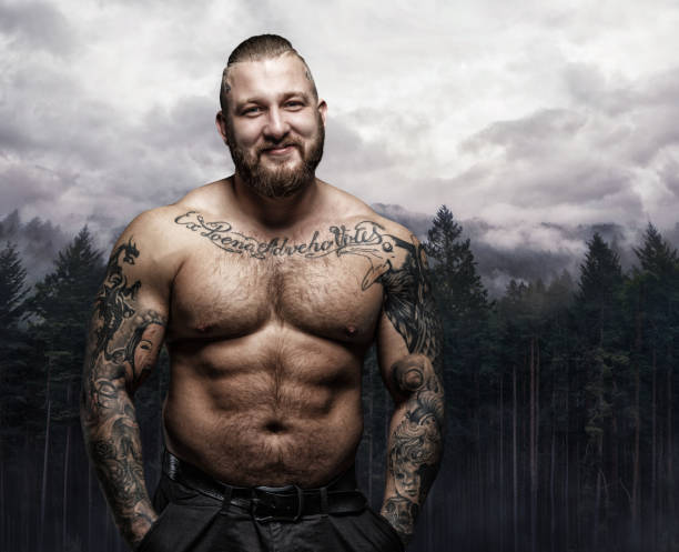 smiling tattooed male over nature background. - shirtless men bizarre male imagens e fotografias de stock