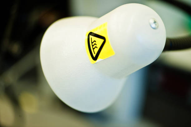 istock Warning or Hazard  Sign / Label: Hot Surface. High Temperature Sign On A Lamp Head 946884472