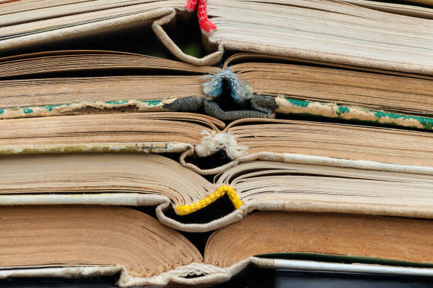 istock Closeup view of pile a opened books 946884836