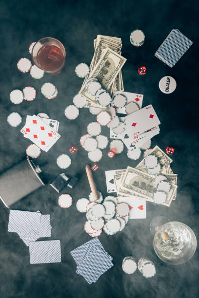 istock Smoke over chips and money on casino table 946884866