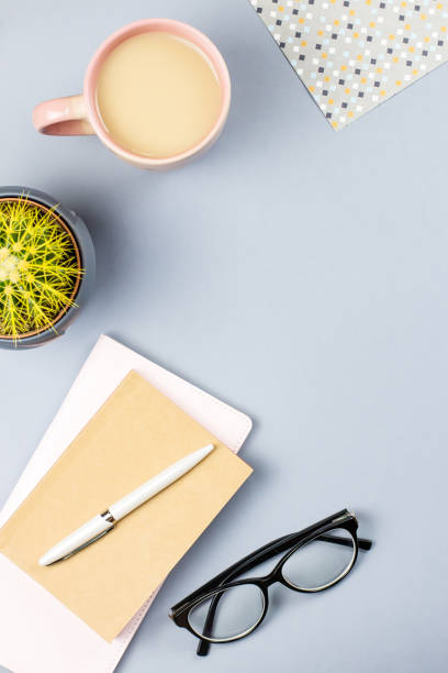 istock Flat lay home office desk. Female workspace with note book, eyeglasses, tea mug, diary, plant. Copy space 946894184