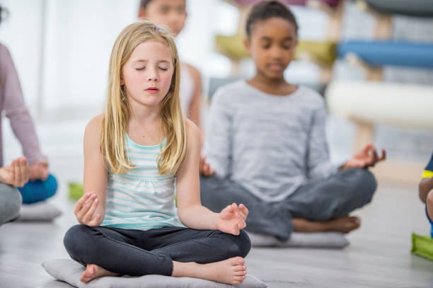 istock Kids Meditating With Eyes Closed 946898090