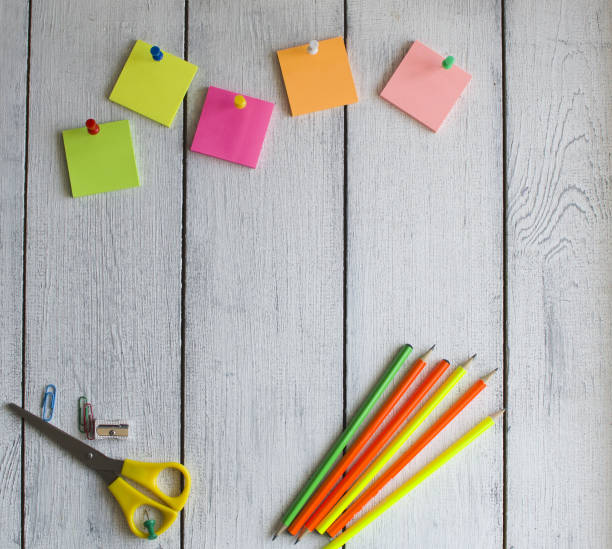 istock Background with neon stickers and colorful pencils, yellow scissors and empty place (horizontally) 946909044