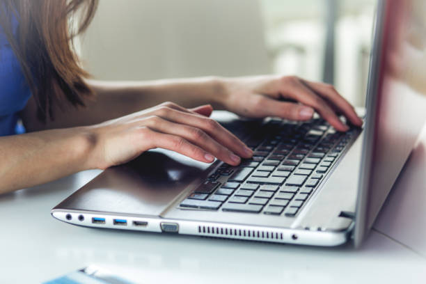istock women's hands on laptop keyboard 946909262