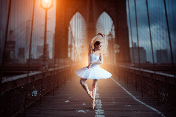 istock Ballet dancer dancing on the bridge in the evening 946909834
