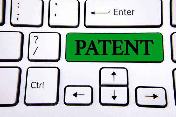 istock Handwriting text writing Patent. Concept meaning License that gives rights for using selling making a product written on Green Key Button on White Keyboard with copy space. Top view. 946919608