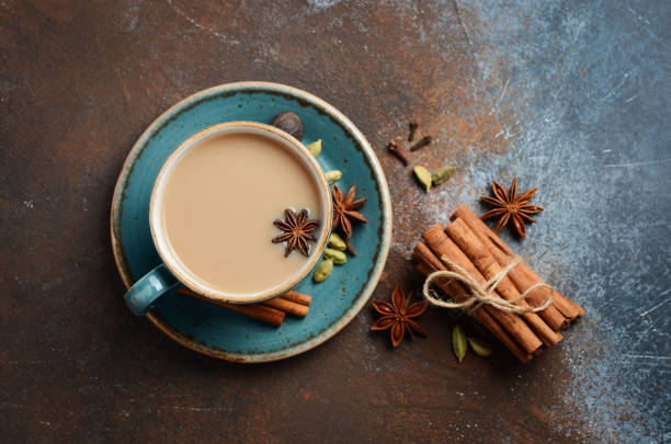 istock Indian masala chai tea. Spiced tea with milk on dark rusty background. 946927472