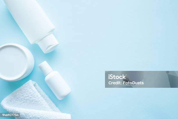 Different White Beauty Toiletries On Blue Background Mock Up For Special Offers As Advertising Or Other Ideas Care About Mens Womens And Kids Hair And Body Skin Empty Place For Text Or Logo Stock Photo - Download Image Now