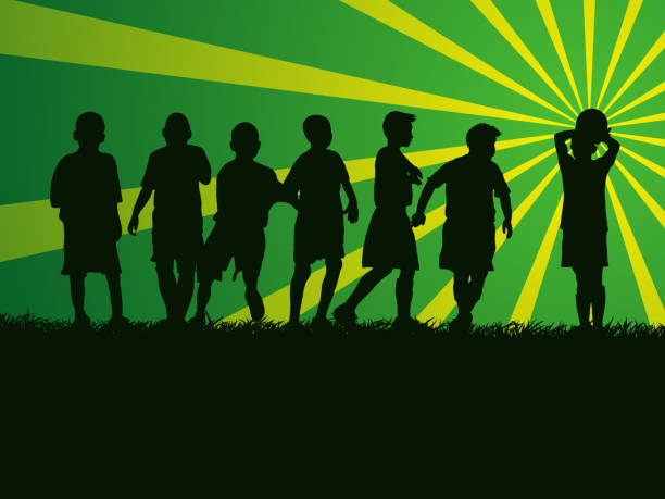 силуэт группы детей, играющих в футбол на травяном поле - youth league stock illustrations