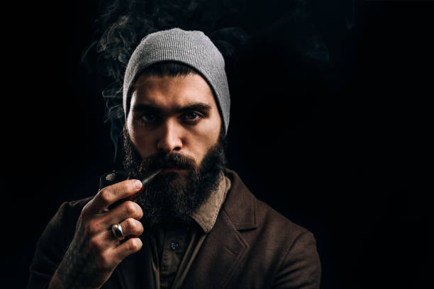 istock Beard man smoking tobacco pipe 946935096