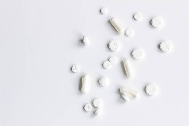 istock Background of white assorted pharmaceutical capsules and medication, copy space 946935170