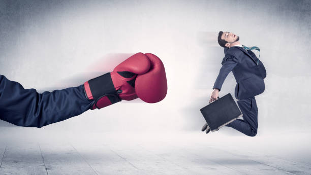 istock Huge Boxing Gloves punches businessman concept 946938044
