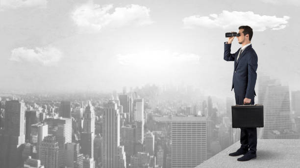 istock Man looking forward from the top of a skyscraper 946938704