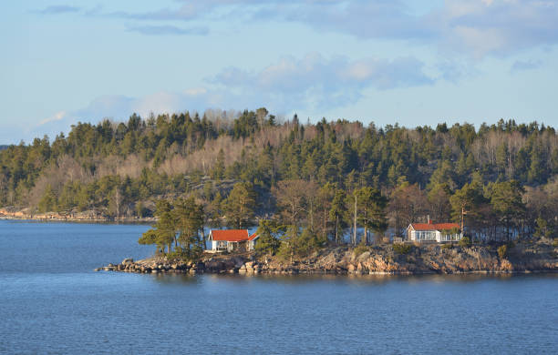 istock Stockholm archipelago, largest archipelago in Sweden, and second-largest archipelago in Baltic Sea. Rocky island with houses and cottages in spring 946938874