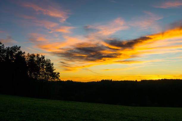 istock Germany, Fire sunset cloud formations in nature of black forest landscape 946939214