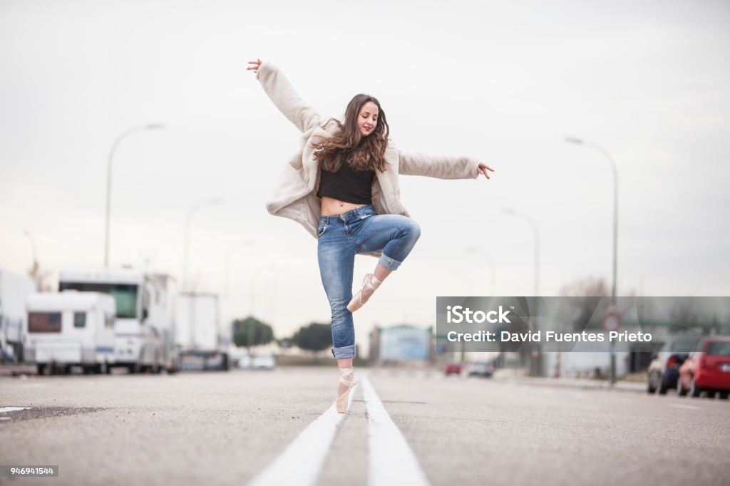 Ballerina in the middle of the avenue Ballerina dance on the asphalt of the avenue Dancing Stock Photo