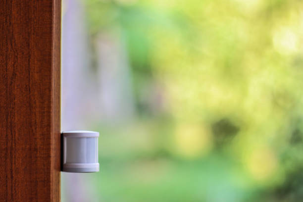 IR Motion sensor attached to a wooden door stock photo
