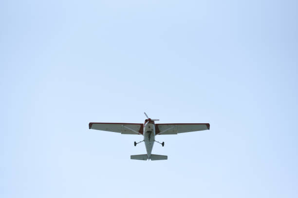 istock The light airplane flies low overhead on a blue sky background 946956384
