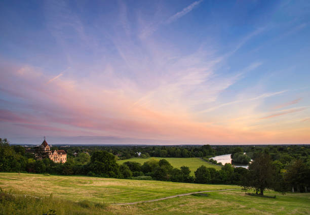 Colorful sunset landscape over fields and River Thames on Richmond Hill in London. stock photo