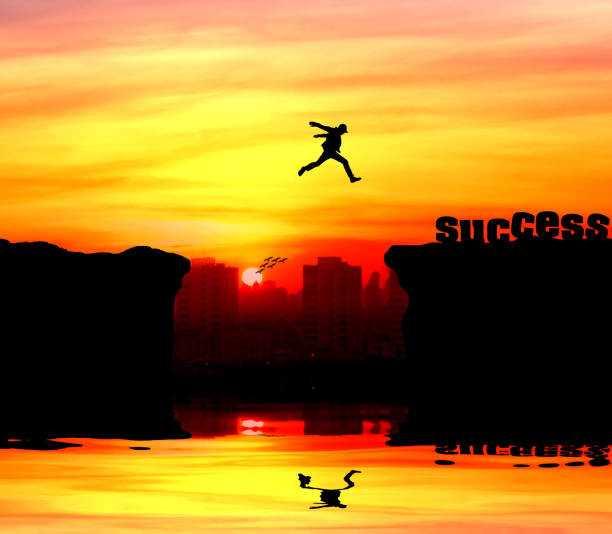 istock Silhouette of a man jumping over the cliff 946961804