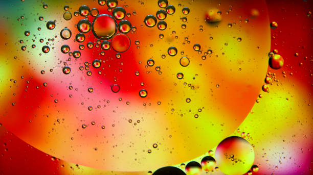 istock Abstract yellow-red oil circles on the water. 946962112