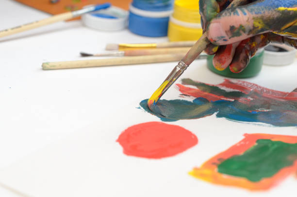 istock A child's hand in paint paints gouache on white paper. 946965158