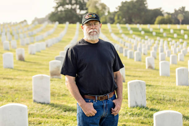 istock Authentic Vietnam Veteran Walking in Military Cemetary 946969028