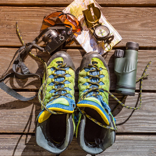 Map, compass, camera, monocular, glasses and hiking shoes for traveling