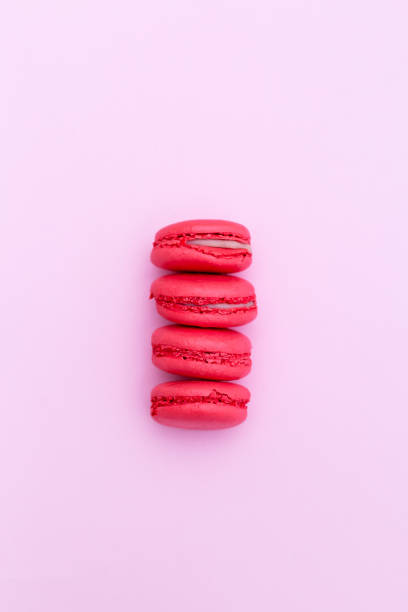 istock Strawberry macaroons on pink background. Vertical 946969364