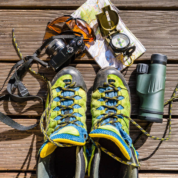 istock Map, compass, camera, monocular, glasses and hiking shoes for traveling 946969388