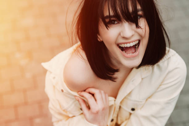 Young attractive woman laughing and looking at camera.
