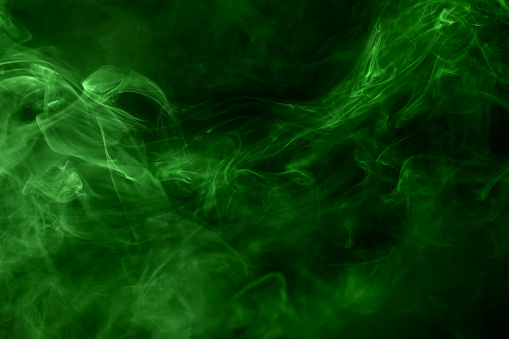 Poisonous green smoke close up on black. Texture and background