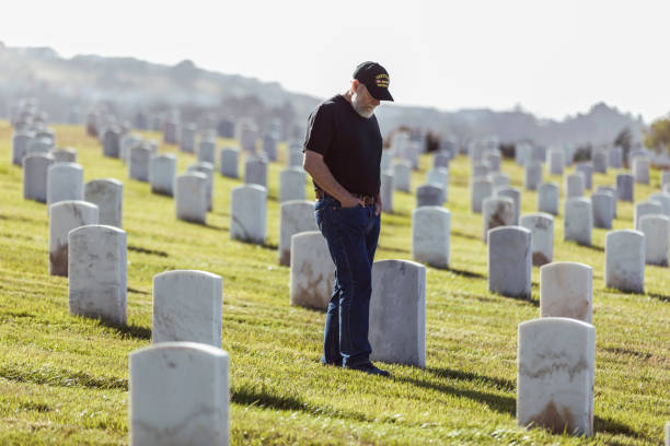 istock Authentic Vietnam Veteran Walking in Military Cemetary 946975716