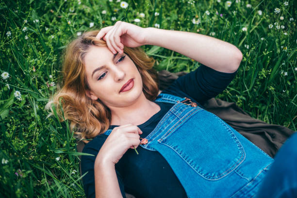 istock Spring girl lying on the field 946976754