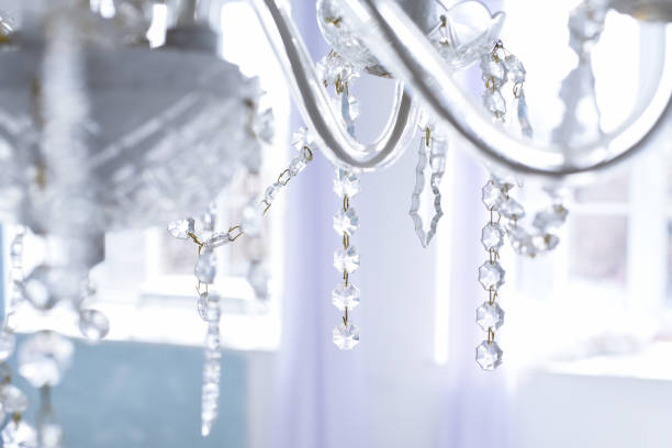 istock Suspended crystal chandelier in a bright room 946981028