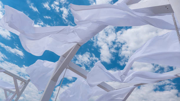 istock Sheds  awning with fabric white curtains on the seashore breeze in the wind 946987212