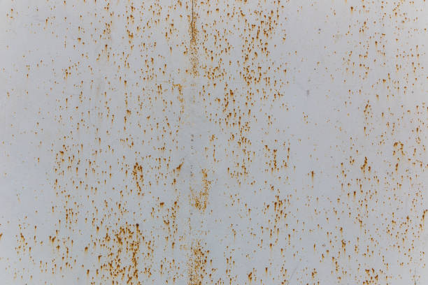 The texture of painted metal gates covered with shallow rust