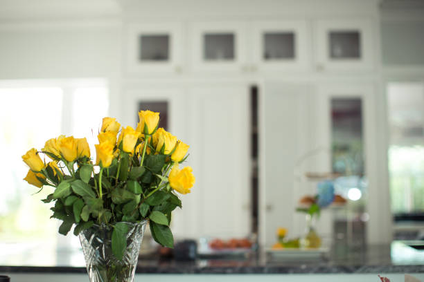 bouquet of yellow roses in white kitchen interior