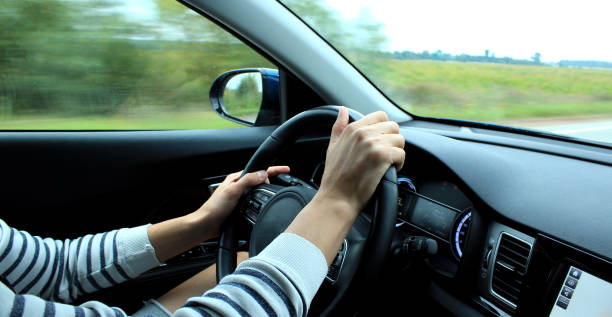 istock Incorrect hands position on the steering wheel inside fast moving vehicle 946991162