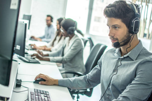 istock Handsome young male customer support executive working in office. 946991526