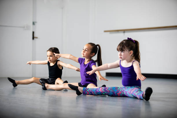 Group of Children Practicing Dance at Studio Cute group of diverse children practicing at dance studio jazz dancing stock pictures, royalty-free photos & images