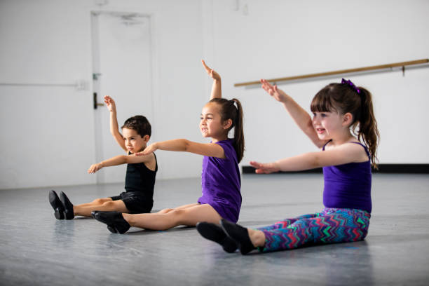 Group of Children Practicing Dance at Studio Cute group of diverse children practicing at dance studio jazz dancing stock pictures, royalty-free photos & images