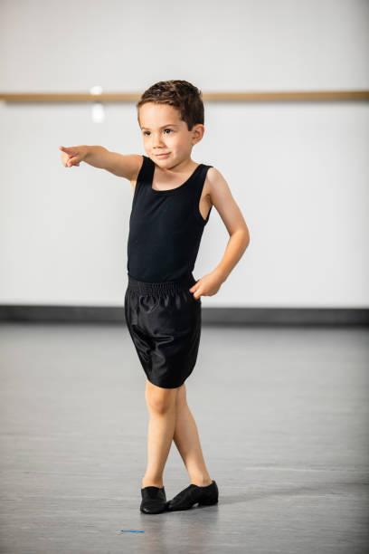 Cute little hispanic boy practicing dance at studio Little boy practicing at dance studio jazz dancing stock pictures, royalty-free photos & images