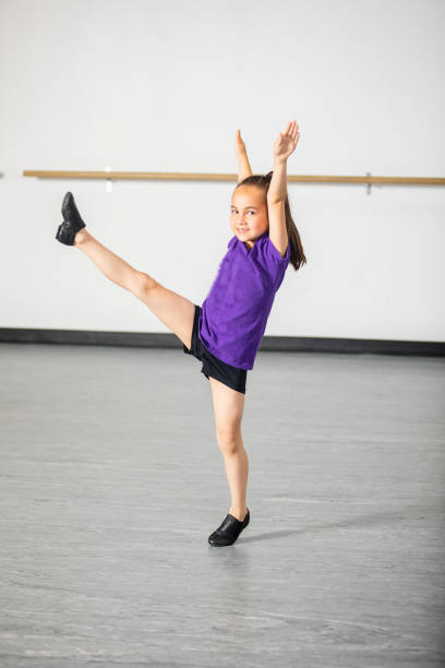 Cute little girl practicing at dance studio Cute group of diverse children practicing at dance studio jazz dancing stock pictures, royalty-free photos & images